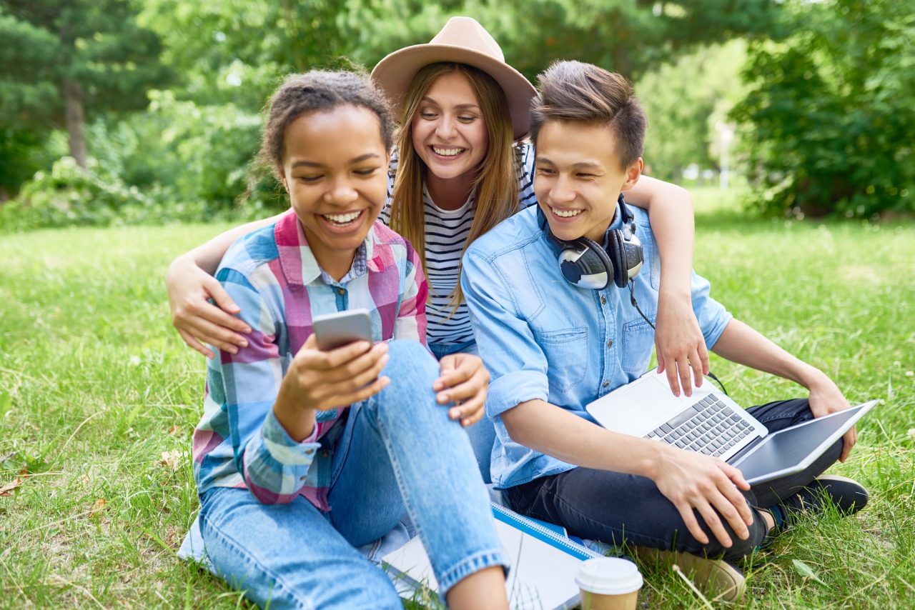 happy students enjoying break on green lawn HIPAA Learning Academy